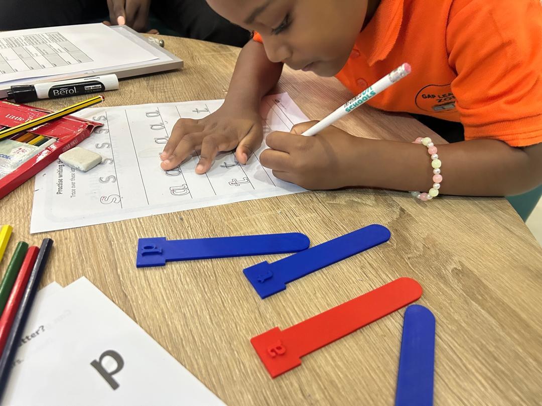 Child practising literacy and handwriting at GAP Learning Zone